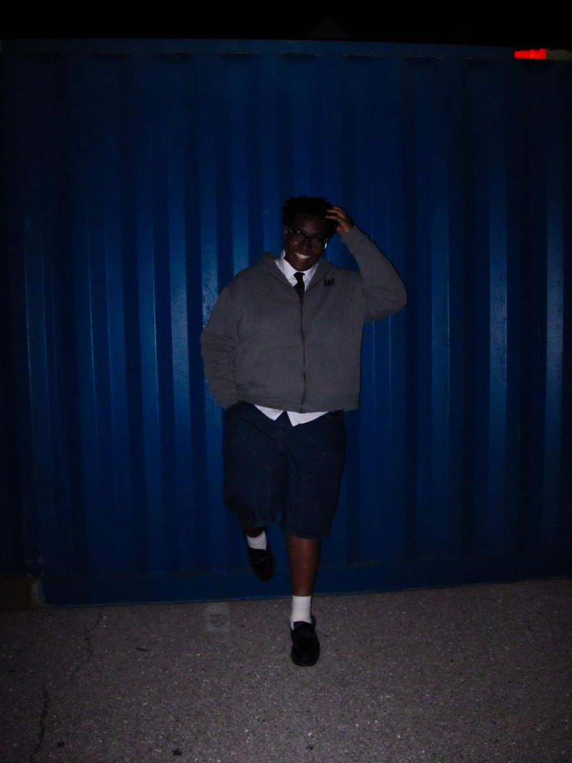 Richard by a blue shipping container